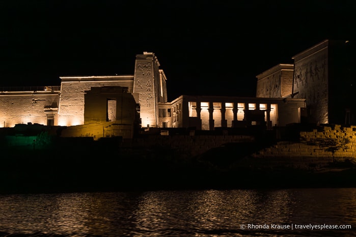 View from the boat of Philae Temple illuminated at night.