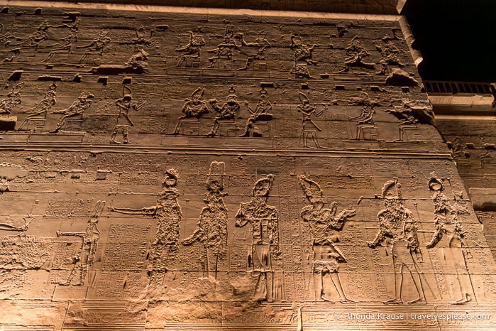 Carvings on the exterior of Philae Temple at night.