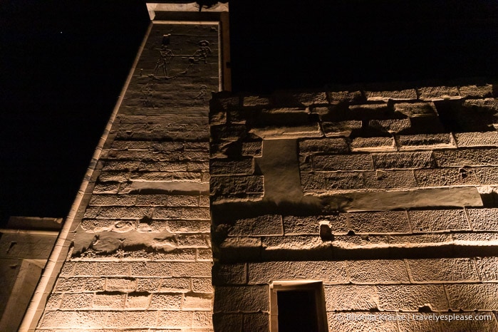 Lights shining on an exterior wall of the temple.