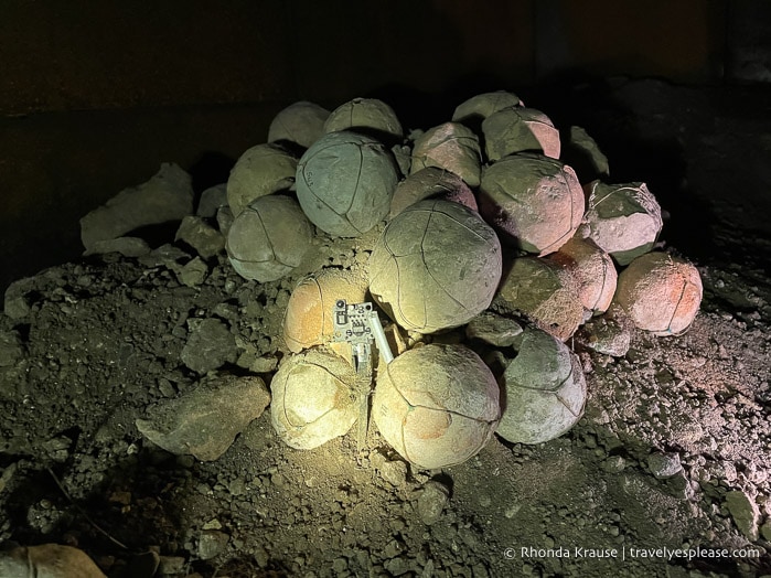 A light activated sensor in front of a pile of stone balls.