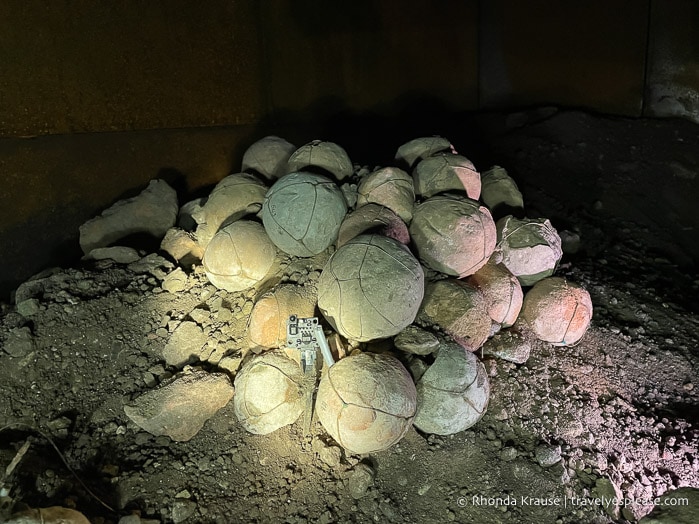 A light activated sensor in front of a pile of stone balls.