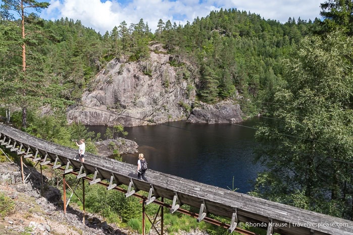 Hikers on the log chute beside the Otra river.