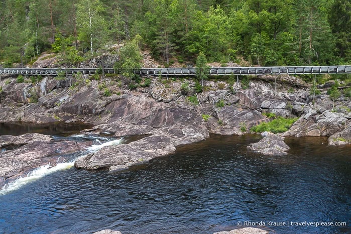 Log chute on the rocky banks of the Otra river.