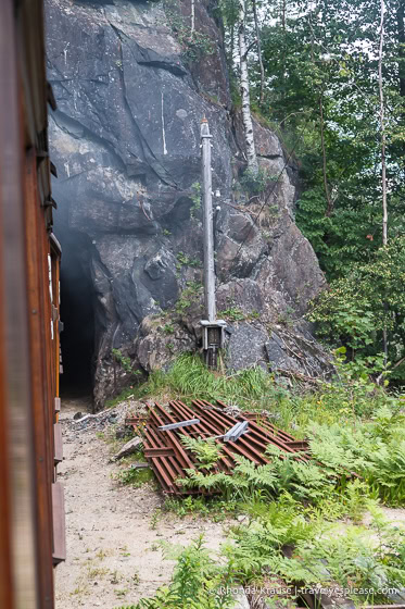 View looking out a window as the train goes into a tunnel.