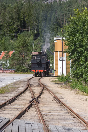 Steam engine filling up at the water tower.