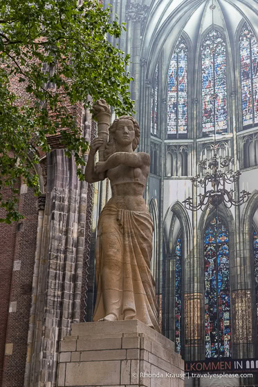 Statue of a female figure holding a flame.