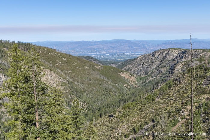 Myra Canyon with Kelowna and Okanagan Lake in the distance.