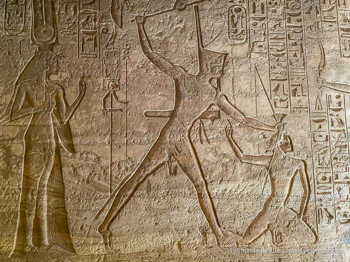 Relief of Ramesses II striking his enemies as Nefertari looks on.