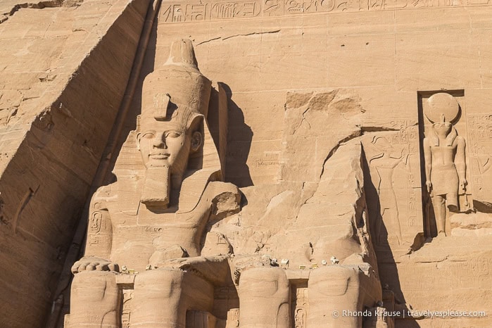 Two seated statues of Ramesses the Great- one is intact and one is missing the upper body.