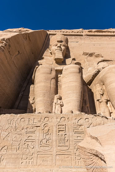 Statue of Ramesses II and hieroglyphs on the facade of the Great Temple.