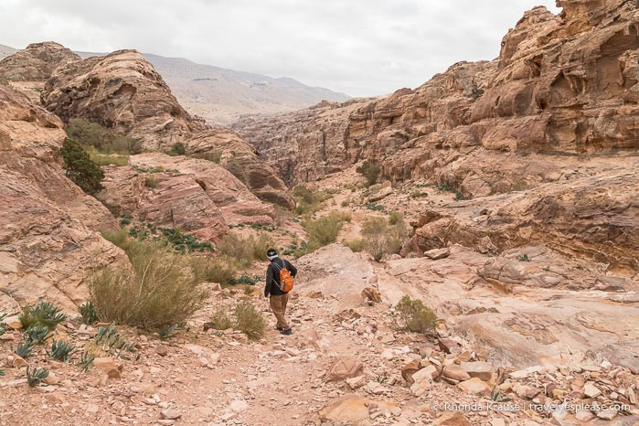 Hiker framed by rocks in the valley.