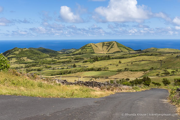 Road on Pico Island with views of hills and the ocean. 