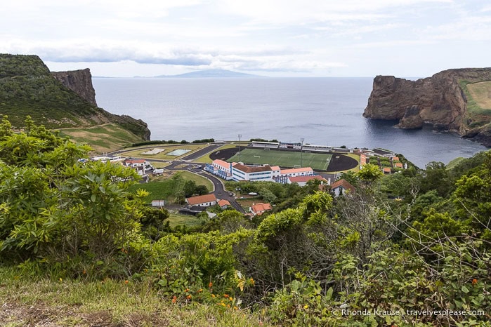 A soccer field alongside a bay between two submarine volcanos. 