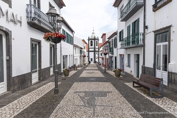 Cobblestone street and white buildings in Velas. 
